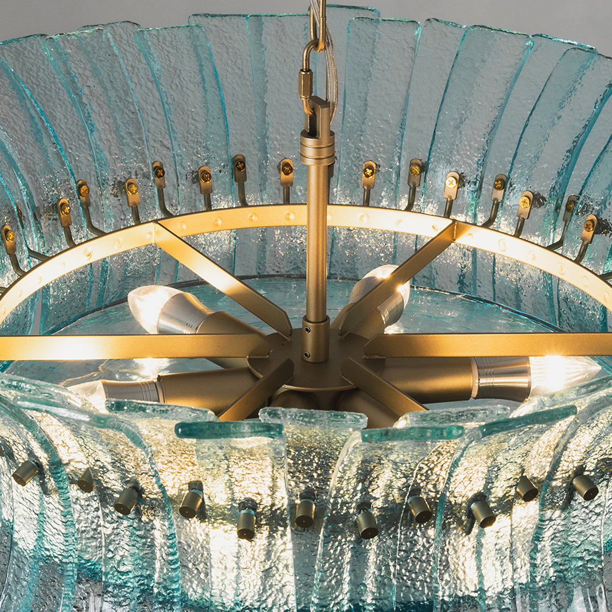 Azura Aquamarine Cascading Glass Chandelier | Glass, Metal | Close-up internal view looking inside the radial gold brass frame core and light bulb sockets through the top ring | Detail shot | Severn Lighting