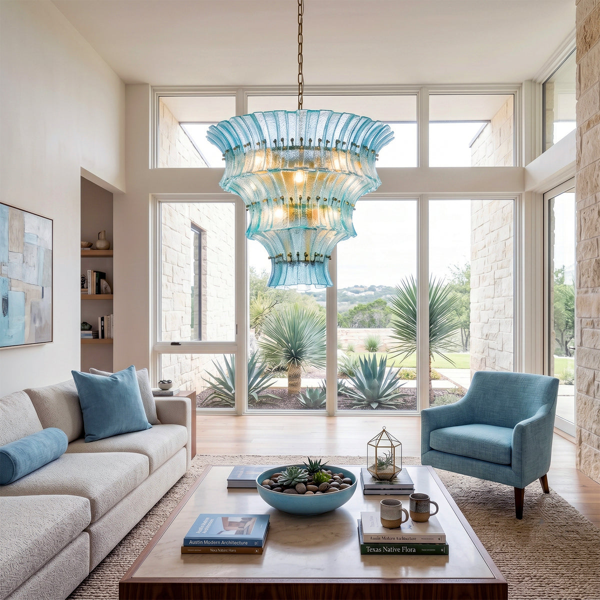 Azura Aquamarine Cascading Glass Chandelier | Glass, Metal | Hanging beautifully in a bright, spacious modern living room with a grey sectional sofa and a sleek wooden coffee table | Severn Lighting