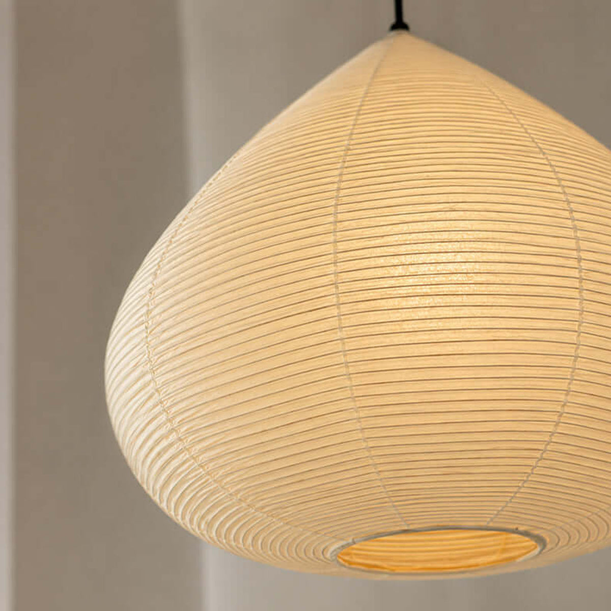 Bryony Teardrop Paper Pendant Light | Washi Paper and Metal | Angled side view of the illuminated teardrop paper shade | Severn Lighting