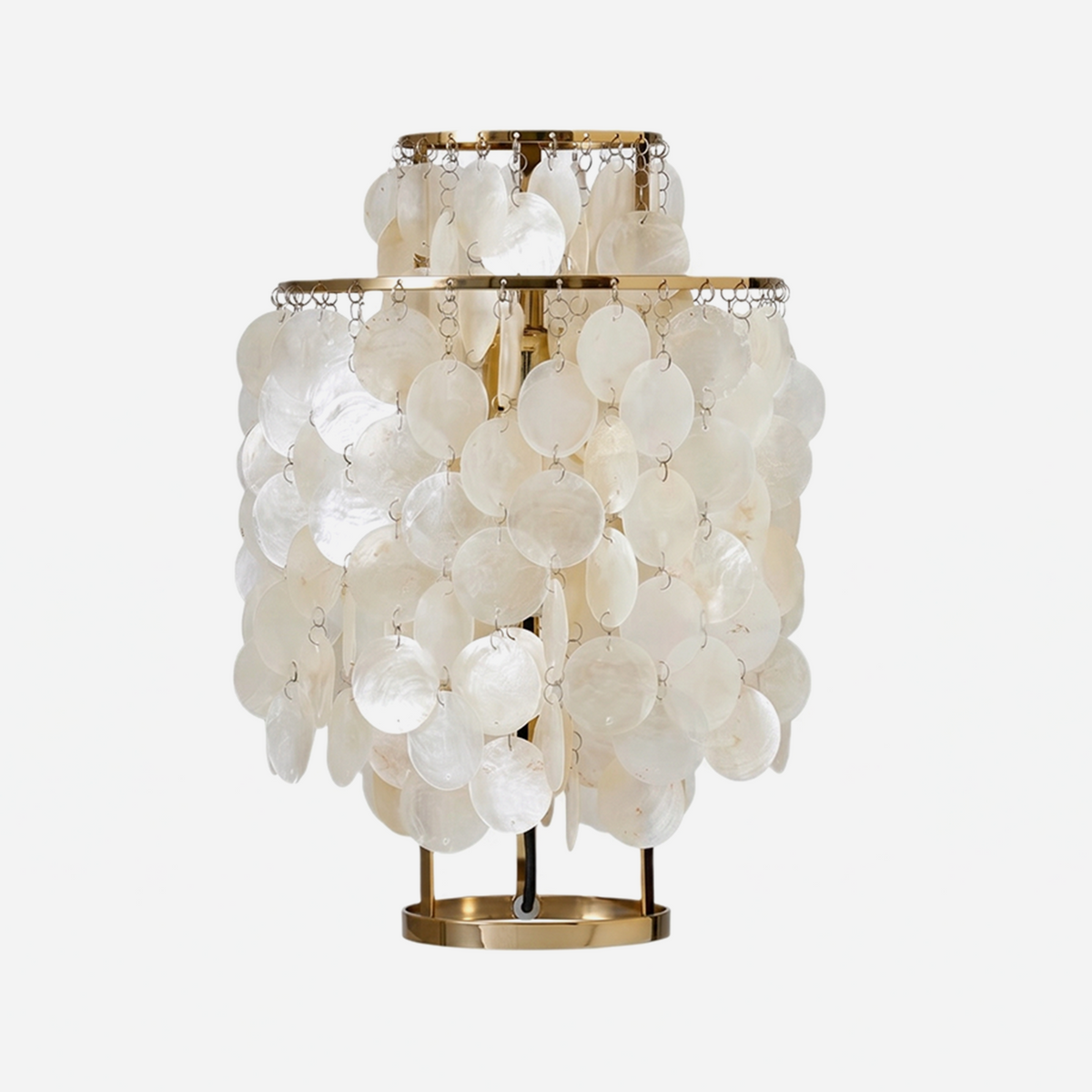 Callista Tiered Capiz Table Lamp | Capiz, Metal | Isolated unlit view of a coastal chic tiered table lamp featuring multiple concentric layers of round translucent white capiz shell discs on a circular gold brass base | White background | Severn Lighting
