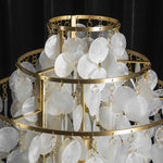 Callista Tiered Capiz Table Lamp | Capiz, Metal | Top-down structural perspective of the concentric circular gold frames densely packed with hanging strands of capiz shells on a black background | Detail shot | Severn Lighting