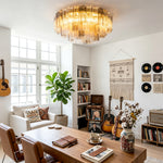 Cassian Tiered Fluted Glass Ceiling Light | Tiered Fluted Glass and Gold Brass | Positioned in a cozy boho-chic living area with a wooden table, guitars, and vinyl records on the wall | Severn Lighting