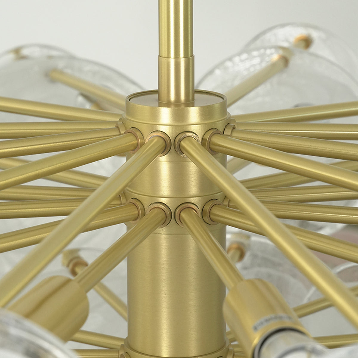 Celestia Art Glass Disc Chandelier | Glass, Metal | Up-close structural view of the brushed gold brass central sphere core and radial frame spokes with sockets | Detail shot | Severn Lighting