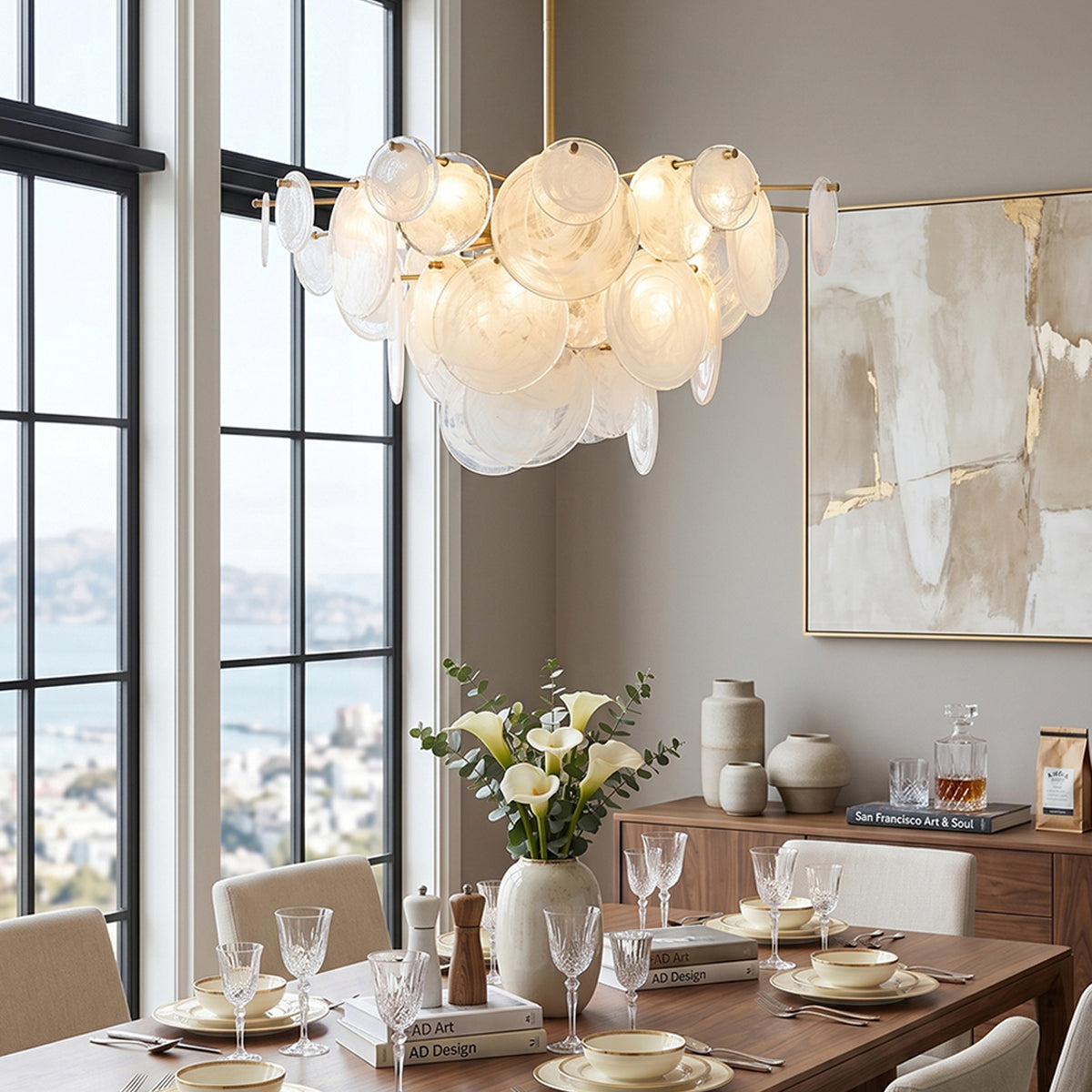 Celestia Art Glass Disc Chandelier | Glass, Metal | Illuminating a contemporary dining room setup, casting a warm ambient glow over a long wood table and minimalist chairs | Severn Lighting