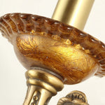 Clemency Winged Figure Brass Sconce | Cast Brass and Glass | Macro view of the textured ornate brass candle dish pattern | Severn Lighting