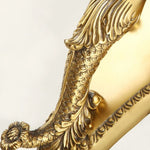 Clemency Winged Figure Brass Sconce | Cast Brass and Glass | Detail shot showing the intricate carved brass backplate and scrollwork | Severn Lighting