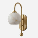 Cordelia Alabaster Globe Wall Sconce | Natural Alabaster and Brushed Brass | Full front studio shot on a clean white background showcasing the arched brass arm and stone globe shade | Severn Lighting