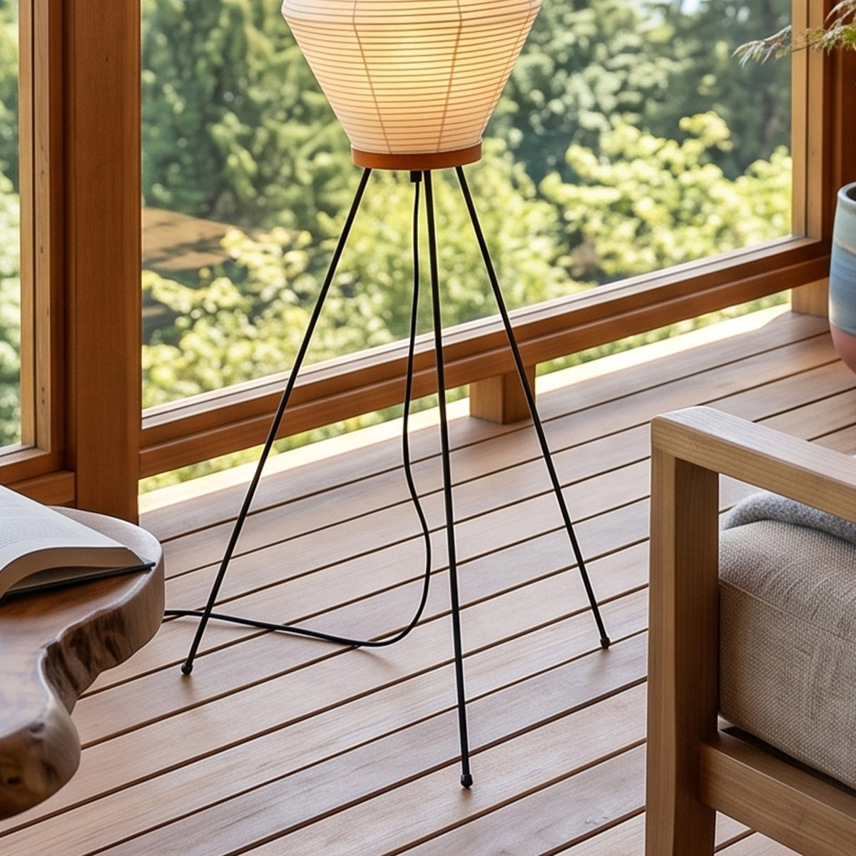 Cosima Hourglass Washi Paper Floor Lamp | Japanese Wabi-Sabi Paper and Black Tripod | Detailed view highlighting the minimal black metal tripod legs resting on a wooden deck floor | Severn Lighting