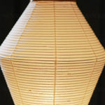 Cosima Hourglass Washi Paper Floor Lamp | Japanese Wabi-Sabi Paper and Black Tripod | Close-up macro view focusing on the warm light filtering through the organic paper fiber texture | Severn Lighting