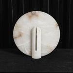 Elvire Alabaster Disc Table Lamp | Natural Alabaster | Full unlit view displaying natural white alabaster veining on a dark backdrop | Severn Lighting