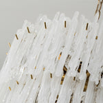 Ethereal Icicle Waterfall Chandelier | Frosted Icicle Glass and Gold Brass | Close-up macro detail of the textured white glass icicles mounted on gold metal pins | Severn Lighting
