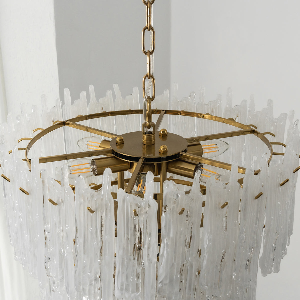 Ethereal Icicle Waterfall Chandelier | Frosted Icicle Glass and Gold Brass | Top-angle unlit product view showing the circular tiered gold frame and hanging glass rods | Severn Lighting