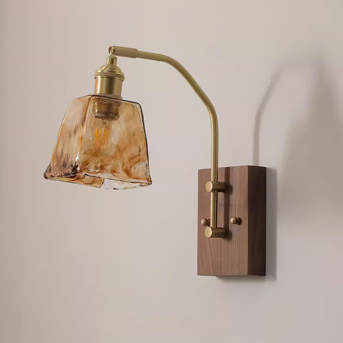 Everett Amber Ripple Wall Sconce | Amber Rippled Glass and Walnut Wood | Angled side view of the fixture hanging fully lit on a clean minimalist backdrop | Severn Lighting