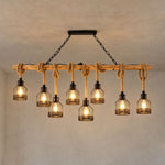 Fermaine Cage Chandelier | Wood, Rope, and Iron | Multi-light long beam model illuminated on textured wall | Severn Lighting