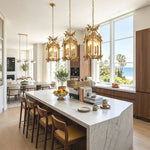 Florian Fretwork Brass Lantern Pendant Light | Glass and Brass | Trio of pendant lights hanging over a marble kitchen island counter | Severn Lighting