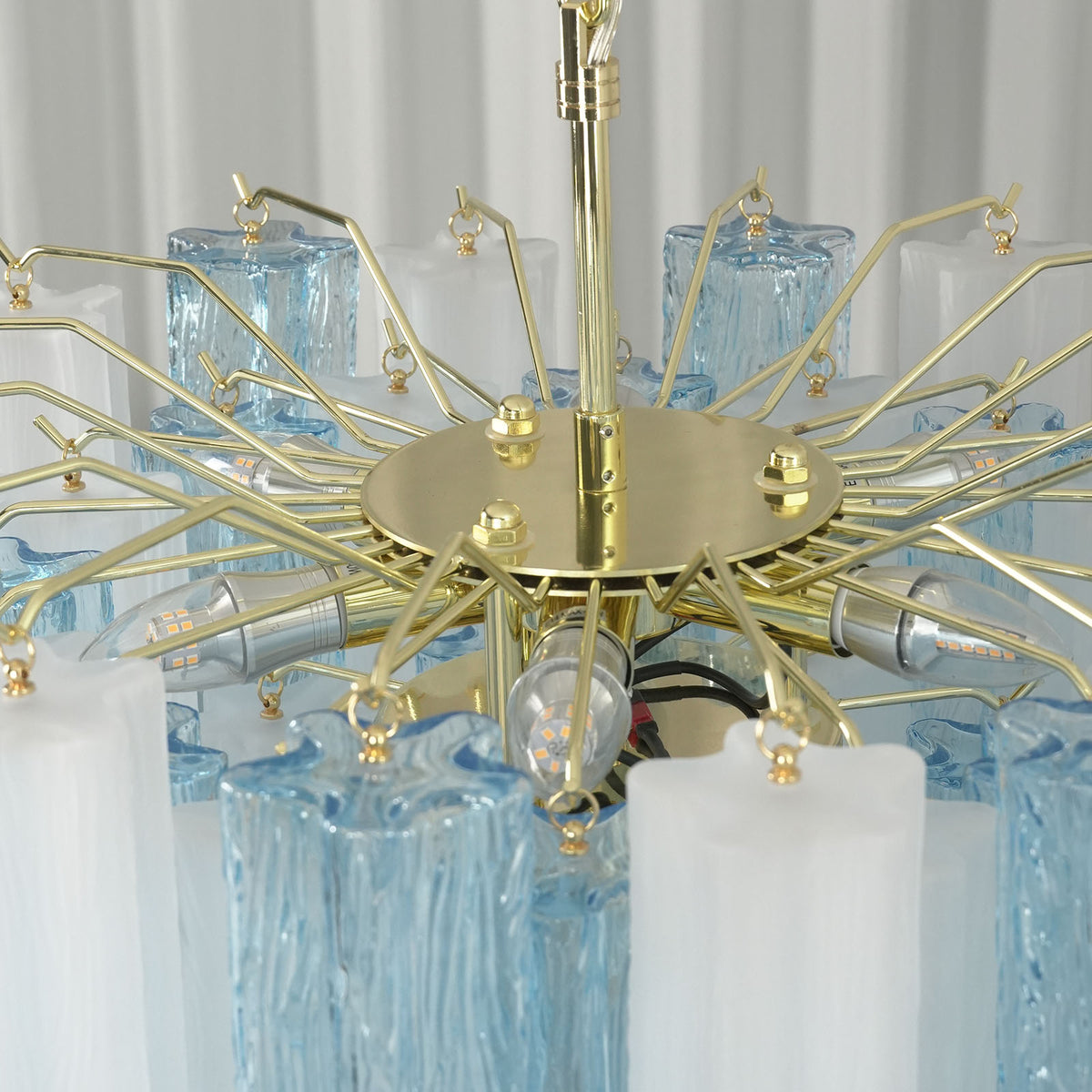 Givrane Two-Tone Glass Tube Tiered Chandelier | Two-Tone Glass and Brass | Top-down angled perspective showing the radiating brass frame structure | Severn Lighting