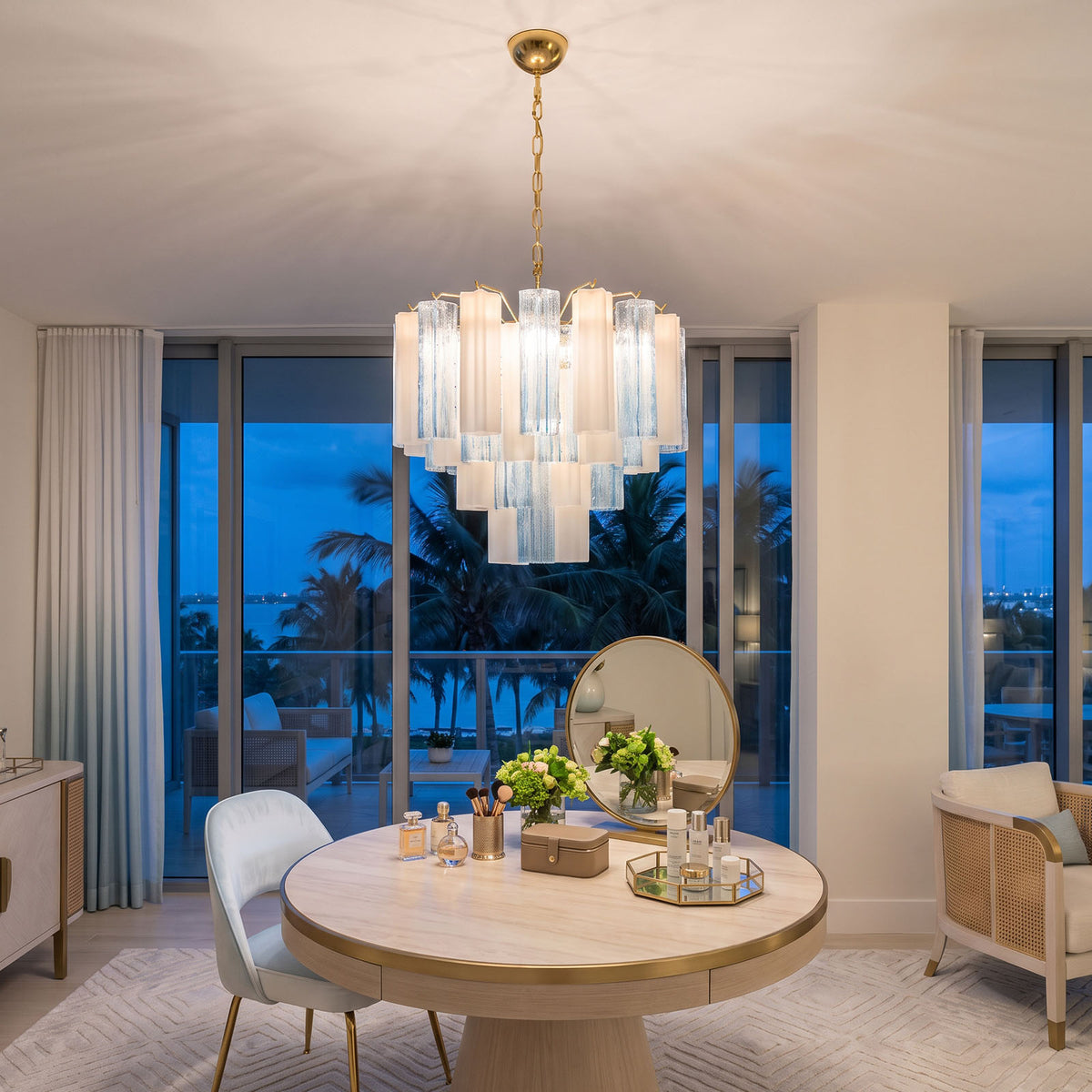 Givrane Two-Tone Glass Tube Tiered Chandelier | Two-Tone Glass and Brass | Hanging over a round table in an elegant suite overlooking twilight views | Severn Lighting