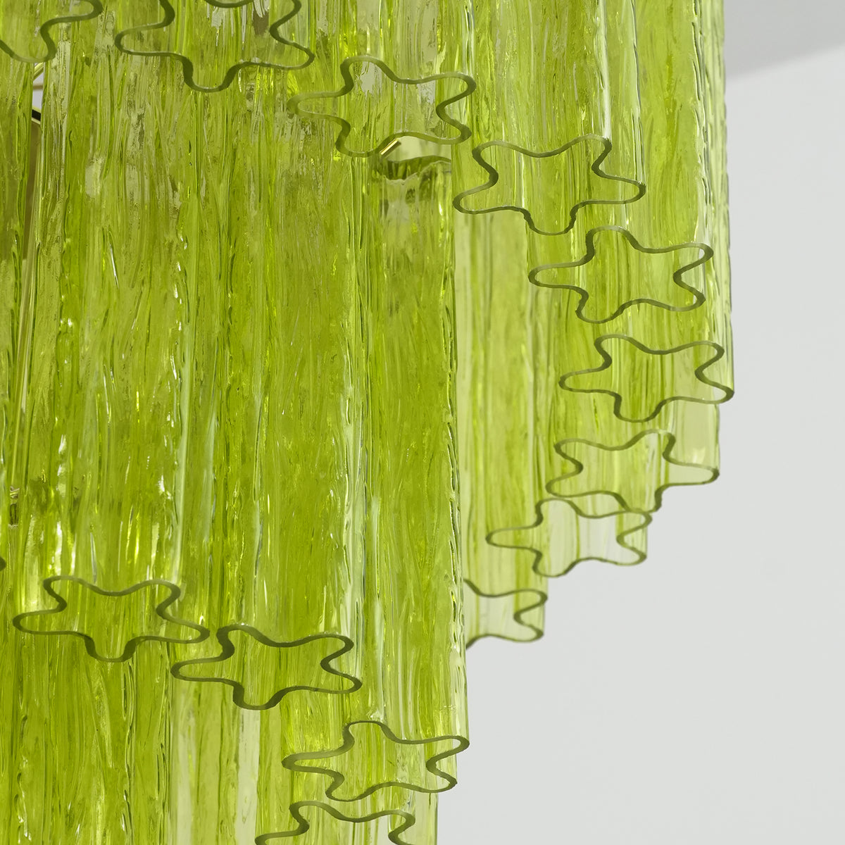 Green Glacier Tier Chandelier | Textured Green Glass | Macro texture shot focusing on the ribbed ice-like surface of overlapping lime green glass pieces | Severn Lighting