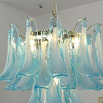 Isar Blue Petal Glass Chandelier | Blue Glass and Brass | Medium close-up showing the central brass frame and glowing blue petals | Severn Lighting