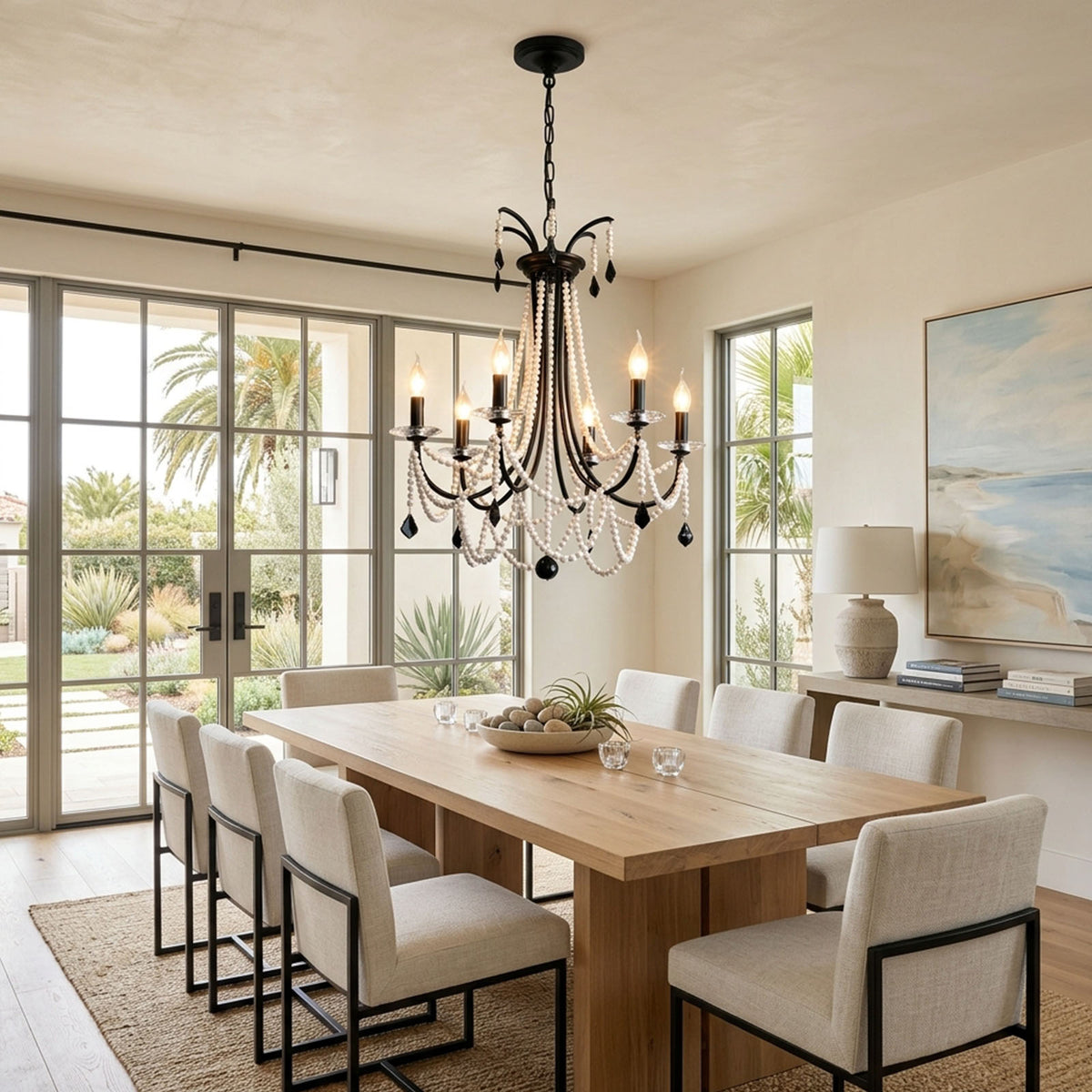 Isolde Pearl Swag Candle Chandelier | Pearl Beads, Crystal and Metal | Suspended over a dining table with light-colored modern chairs | Severn Lighting