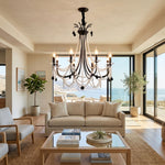 Isolde Pearl Swag Candle Chandelier | Pearl Beads, Crystal and Metal | Centered in a bright sunlit living room with beige sofa and sea view | Severn Lighting