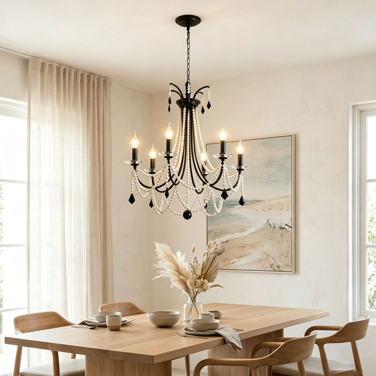 Isolde Pearl Swag Candle Chandelier | Pearl Beads, Crystal and Metal | Placed above a light wooden table in a minimalist dining area | Severn Lighting