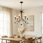 Isolde Pearl Swag Candle Chandelier | Pearl Beads, Crystal and Metal | Placed above a light wooden table in a minimalist dining area | Severn Lighting
