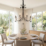Isolde Pearl Swag Candle Chandelier | Pearl Beads, Crystal and Metal | Illuminating a round wooden dining table near bright windows | Severn Lighting