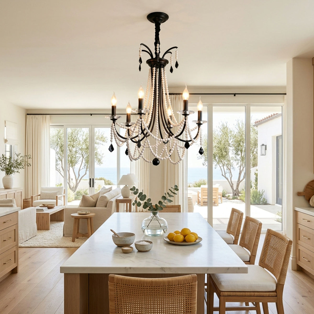 Isolde Pearl Swag Candle Chandelier | Pearl Beads, Crystal and Metal | Displayed over a long wooden dining table in a coastal dining room | Severn Lighting