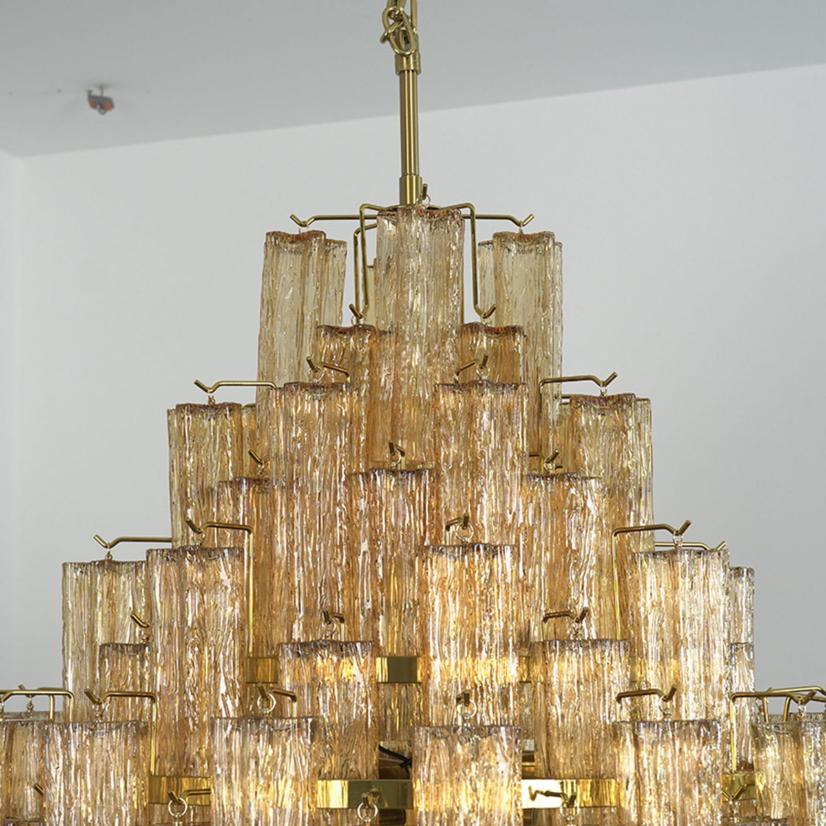 Kester Amber Glass Tier Chandelier | Amber Glass and Brass | Perspective view highlighting the multi-tiered structure and brass hardware | Severn Lighting