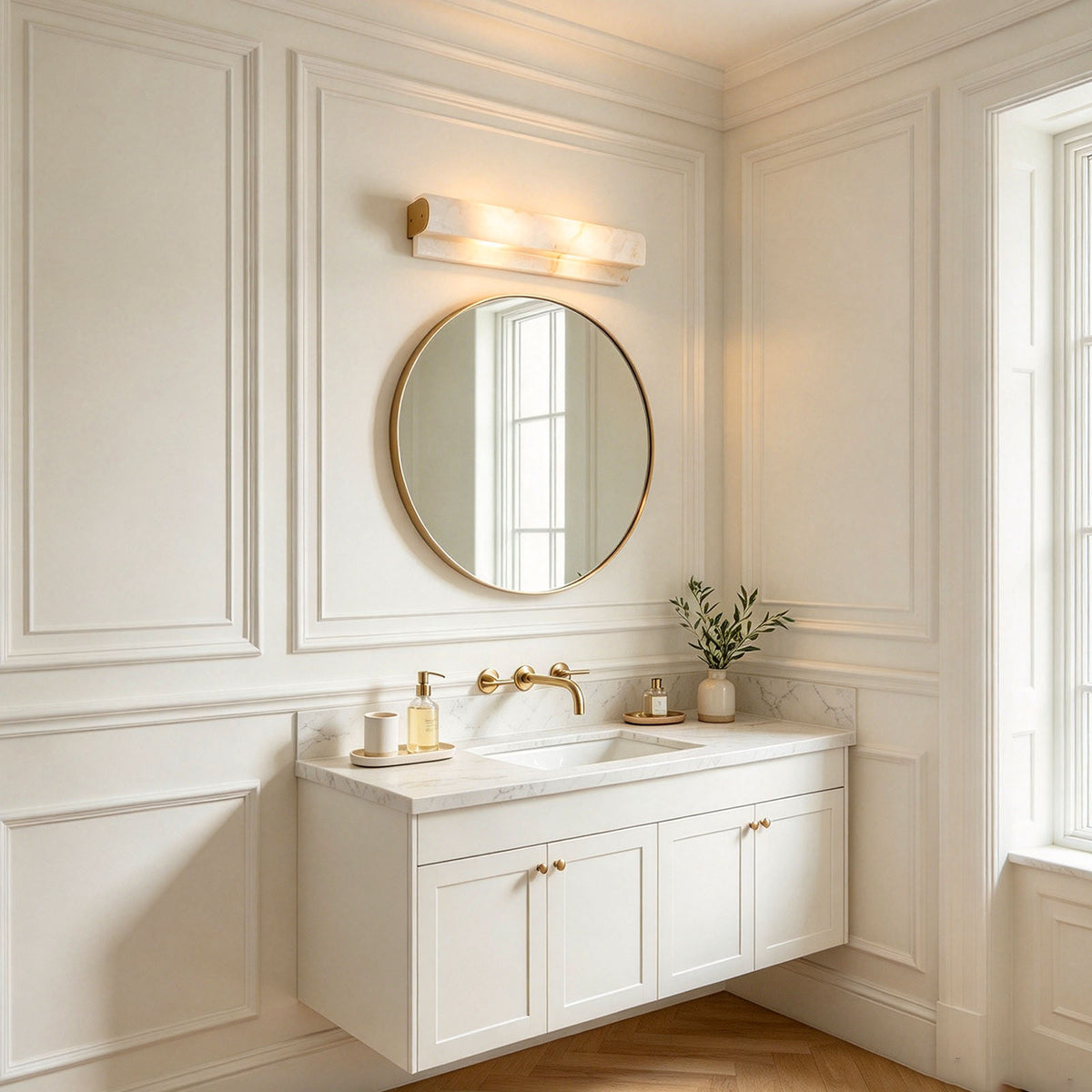 Lamelune Stacked Sconce | Alabaster and Brass | Installed above round mirror in white paneled powder room | Severn Lighting