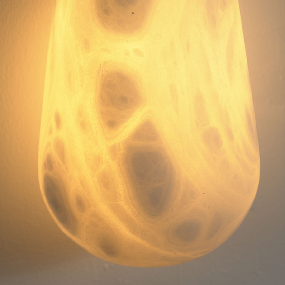 Larmelle Teardrop Sconce | Translucent Alabaster | Macro lit close-up of organic mineral veining and glow | Severn Lighting