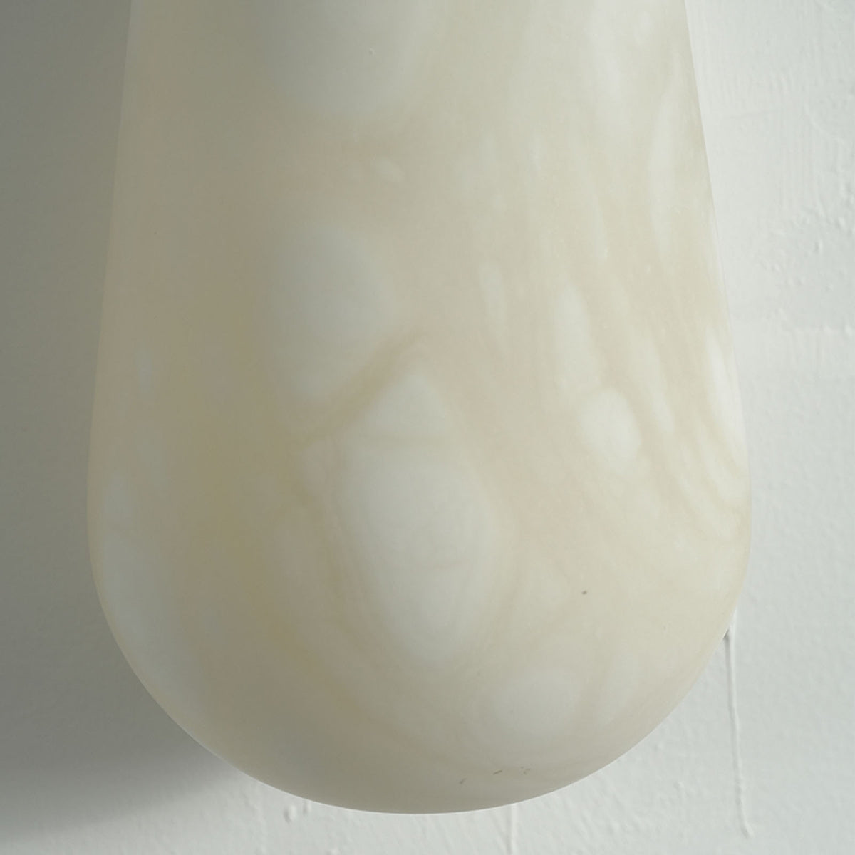 Larmelle Teardrop Sconce | Carved Alabaster | Macro detail of smooth rounded bottom curve on shade | Severn Lighting