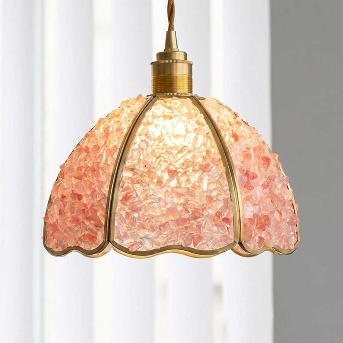 Liora Mosaic Glass Pendant Light | Pink Mosaic Glass and Brass | Standard studio shot of the illuminated pink mosaic shade hanging in front of a light backdrop | Severn Lighting