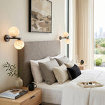 Lucern Twin Globe Alabaster Wall Sconce | Natural Alabaster and Matte Black Metal | Installed as a pair flanking a grey fabric tufted headboard in a modern master bedroom | Severn Lighting