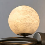 Lucern Twin Globe Alabaster Wall Sconce | Natural Alabaster and Matte Black Metal | Macro detail shot of the top spherical stone globe highlighting its organic earthy textures | Severn Lighting