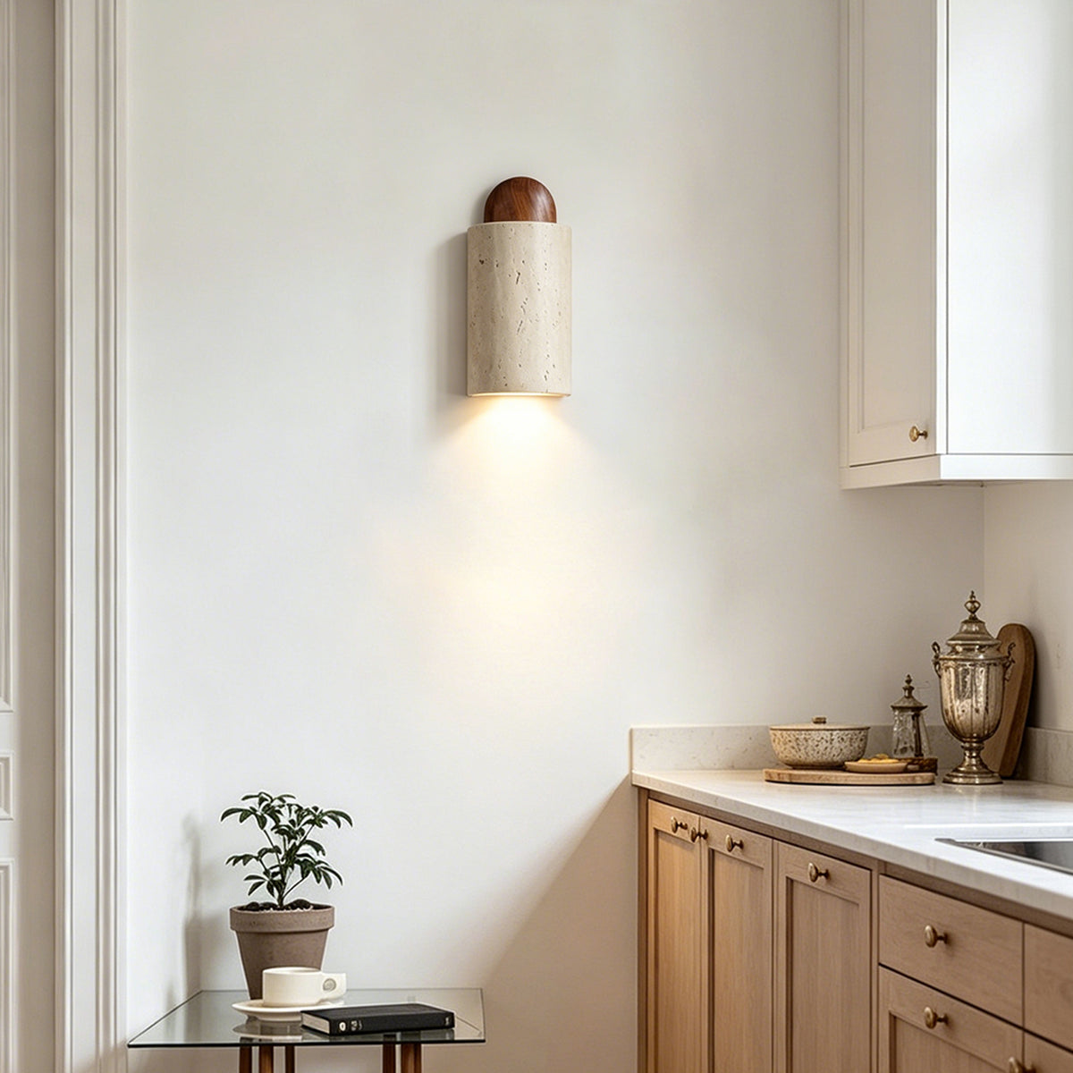 Lyra Travertine Shield Wall Lamp | Travertine, Wood, Metal | Providing warm accent downlighting in a minimalist kitchen setup corner above oak wooden counter cabinets | Severn Lighting