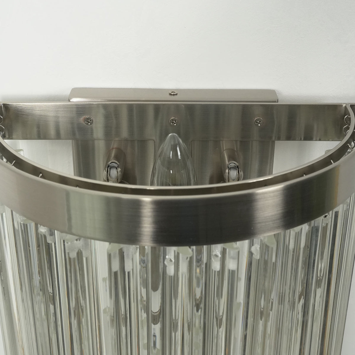 Marelle Glass Rod Tiered Wall Lamp | Clear Glass Rods and Metal | Macro detail shot of the top mounting backplate and metal border | Severn Lighting