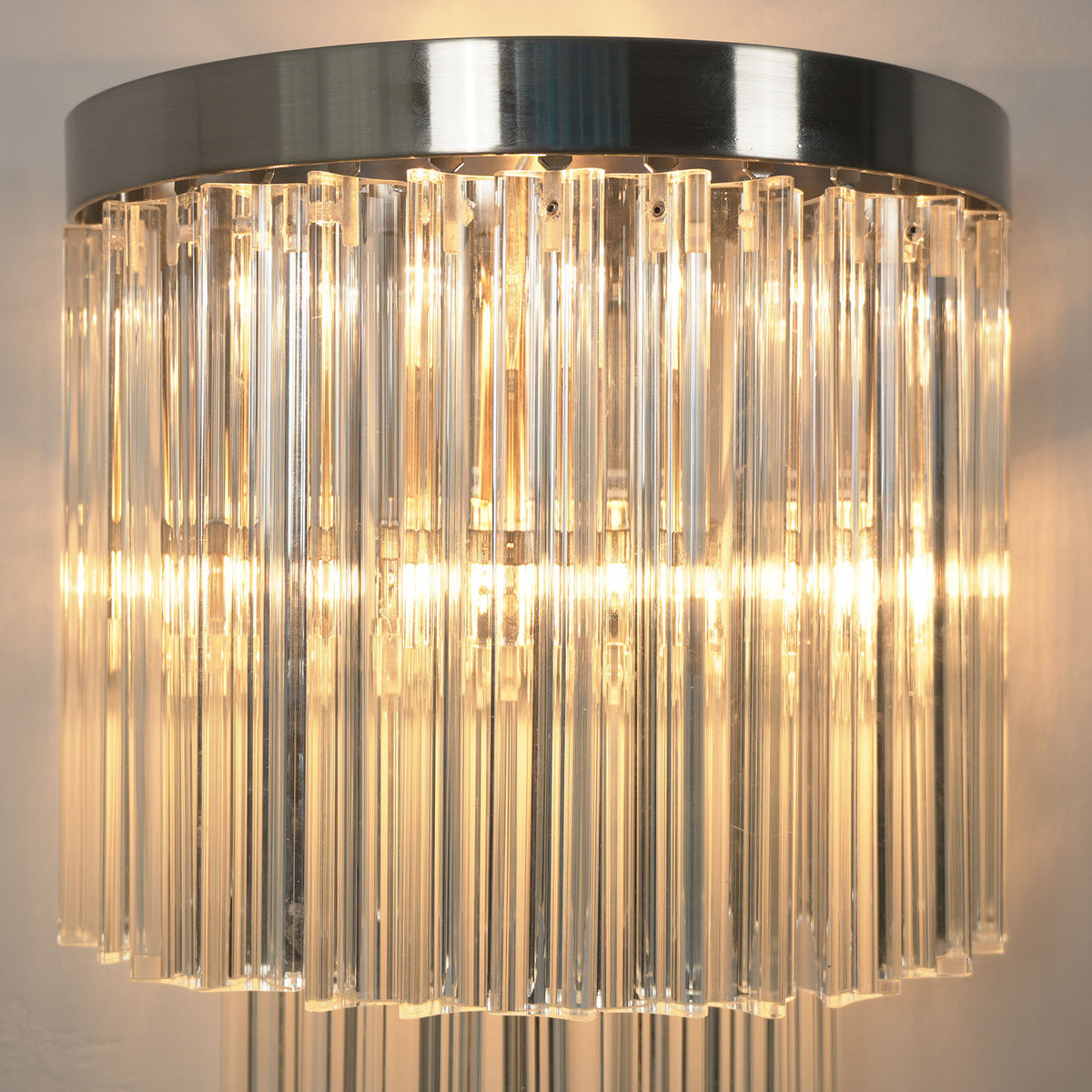 Marelle Glass Rod Tiered Wall Lamp | Clear Glass Rods and Metal | Front close-up shot showing two tiers of illuminated clear glass rods | Severn Lighting