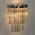 Marelle Glass Rod Tiered Wall Lamp | Clear Glass Rods and Metal | Studio product view glowing brightly displayed against a plain background | Severn Lighting