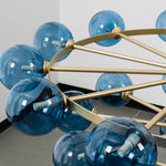 Marisol Aquamarine Glass Bubble Chandelier | Aquamarine Glass and Brass | Close-up top view showing brass radial arms holding blue glass globes | Severn Lighting