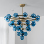 Marisol Aquamarine Glass Bubble Chandelier | Aquamarine Glass and Brass | Side angle perspective of the chandelier installed in a bright space | Severn Lighting