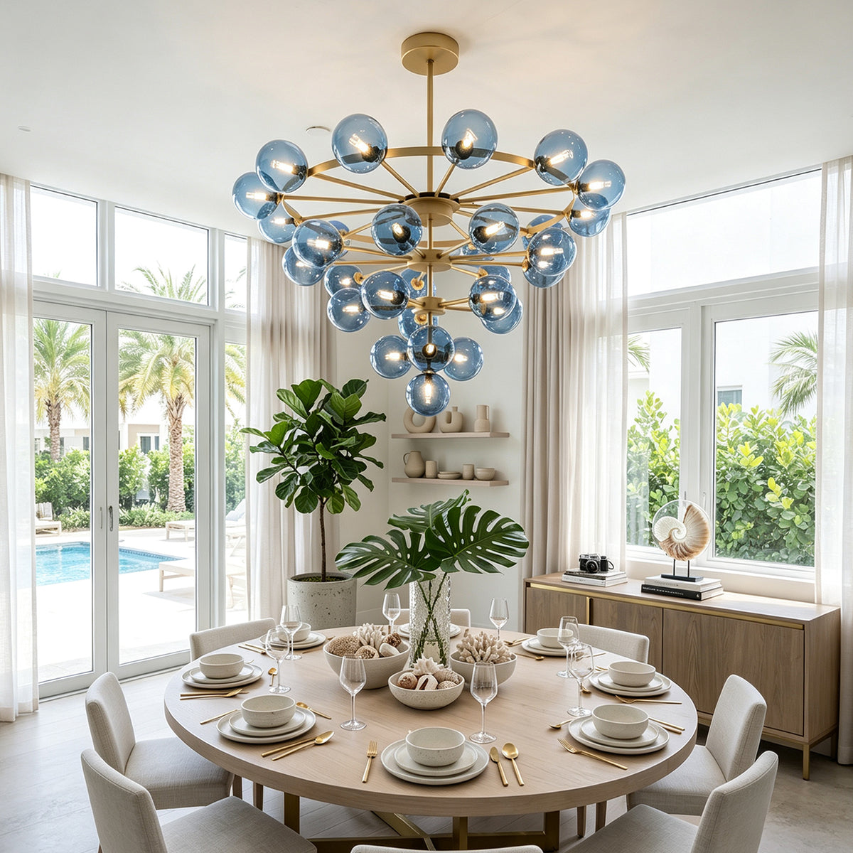 Marisol Aquamarine Glass Bubble Chandelier | Aquamarine Glass and Brass | Hanging above a round dining table in a bright coastal dining room | Severn Lighting