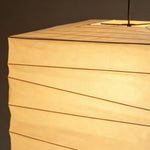 Marlen Squared Paper Column Pendant | Washi Paper and Metal | Close-up detail highlighting the warm glowing ribbed paper texture | Severn Lighting