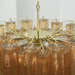 Merlande Amber Glass Tube Tiered Chandelier | Fluted Amber Glass and Brass | Top-down angled view showing the circular brass frame wheel structure | Severn Lighting