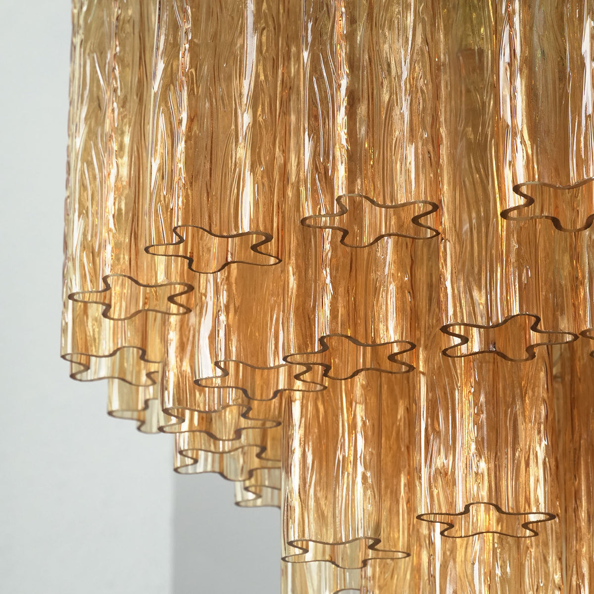 Merlande Amber Glass Tube Tiered Chandelier | Fluted Amber Glass and Brass | Close-up side shot highlighting the lower tier fluted amber glass tubes | Severn Lighting