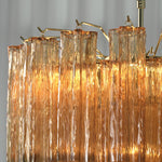 Merlande Amber Glass Tube Tiered Chandelier | Fluted Amber Glass and Brass | Close-up detail of top brass frame hooks and fluted amber glass tubes | Severn Lighting