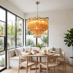 Merlande Amber Glass Tube Tiered Chandelier | Fluted Amber Glass and Brass | Styled over a round dining table with built-in banquette seating | Severn Lighting