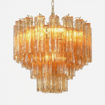 Merlande Amber Glass Tube Tiered Chandelier | Fluted Amber Glass and Brass | Front full view on a pure white background, illuminated | Severn Lighting