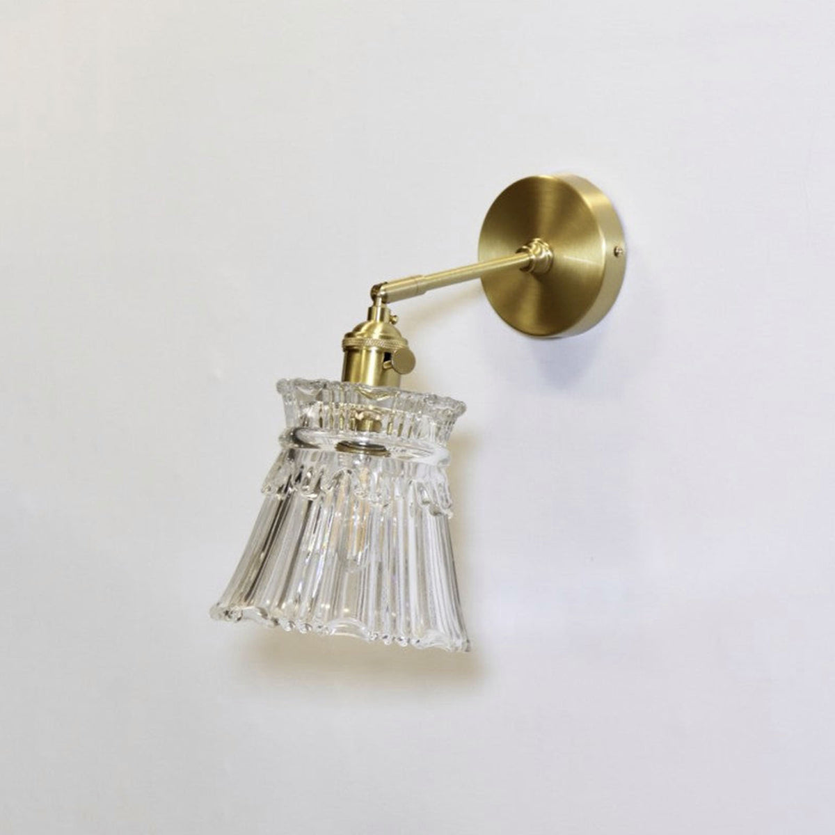 Merrick Fluted Glass Bell Wall Lamp | Fluted Glass and Brass | Unlit full view mounted on a plain white studio background | Severn Lighting